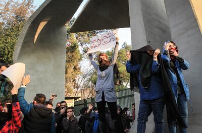 Iranian students protest at the University of Tehran during a demonstration driven by anger over economic problems, in the capital Tehran on December 30, 2017. - Students protested in a third day of demonstrations sparked by anger over Iran's economic problems, videos on social media showed, but were outnumbered by counter-demonstrators. (Photo by STR / AFP)