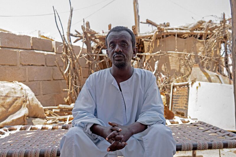 Othman Abubakr, a Sudanese day labourer who has nine children, poses for a picture in the village of Wad Sharifai in Sudan's eastern state of Kassala on September 27, 2022.  There are nearly seven million children in Sudan who no longer go to school, a victim of what aid agencies have warned is a "generational catastrophe".  Children in the country have for years faced mounting difficulties gaining access to proper education, especially in rural areas.  Sudan is already one of the world's poorest countries, plagued by political instability, droughts, hunger and conflict, with an adult literacy rate of only around 60 percent according to the World Bank.  AFP
