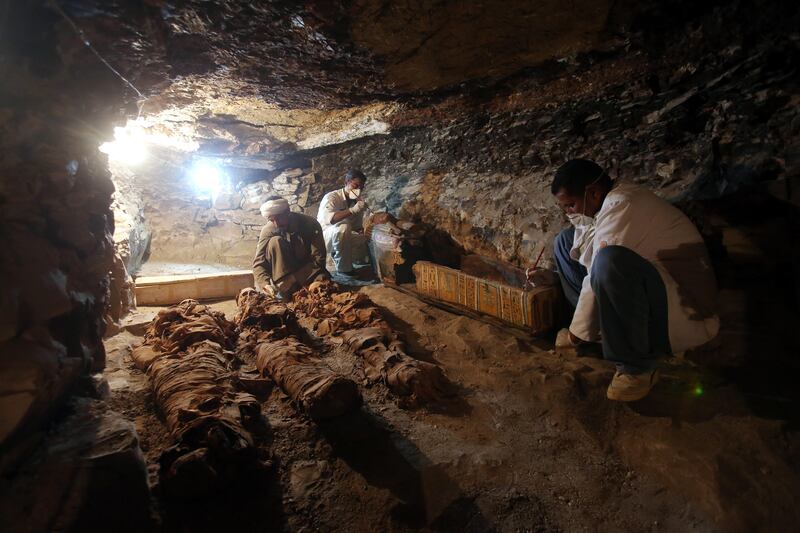 Egyptian archaeologists work on mummies and sarcophagus at a recently discovered tomb in the Draa Abul Nagaa necropolis in Egypt. Khaled Elfiqi / EPA