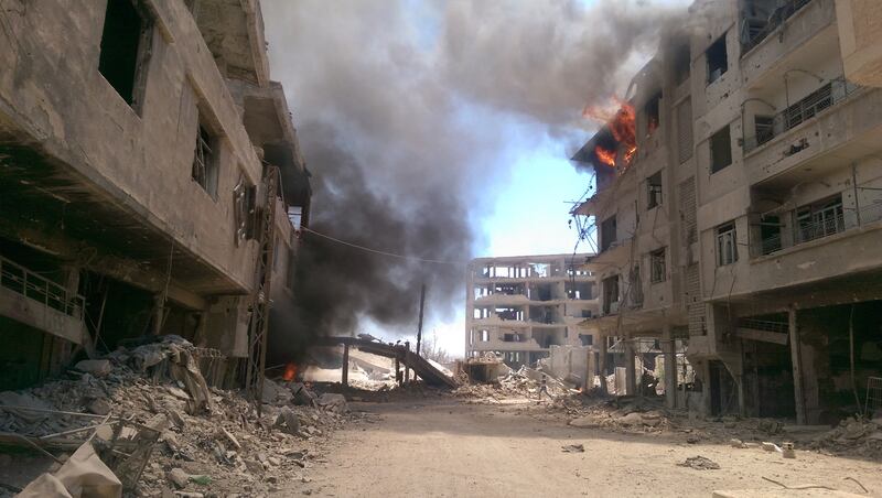 Fires after air strikes on the besieged rebel-held town of Daraya, near the capital Damascus, on August 16, 2016. AFP