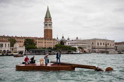 The floating violin hosts musicians from the Benedetto Marcello Conservatory playing Vivaldi from the water. AFP