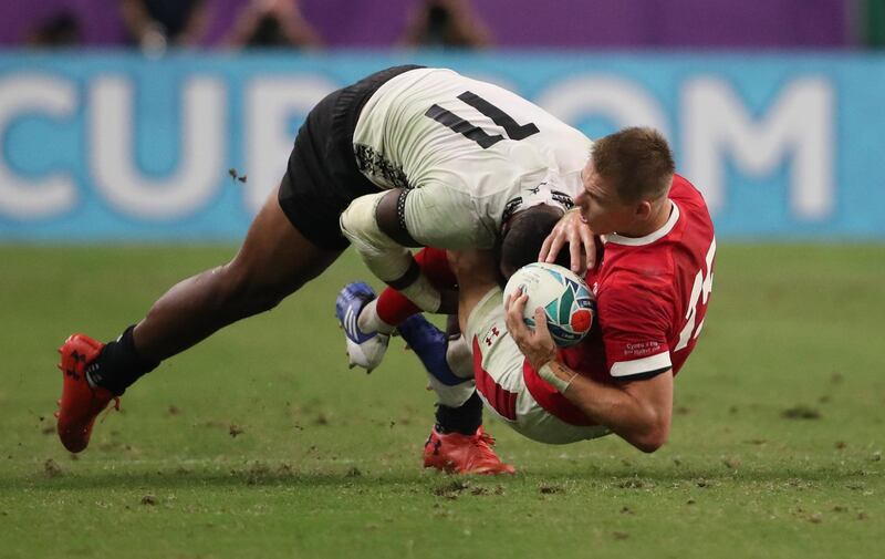 Wales' Liam Williams in action with Fiji's Semi Radradra - Pool D - Wales v Fiji - Oita Stadium, Oita, Japan.  REUTERS/Peter Cziborra