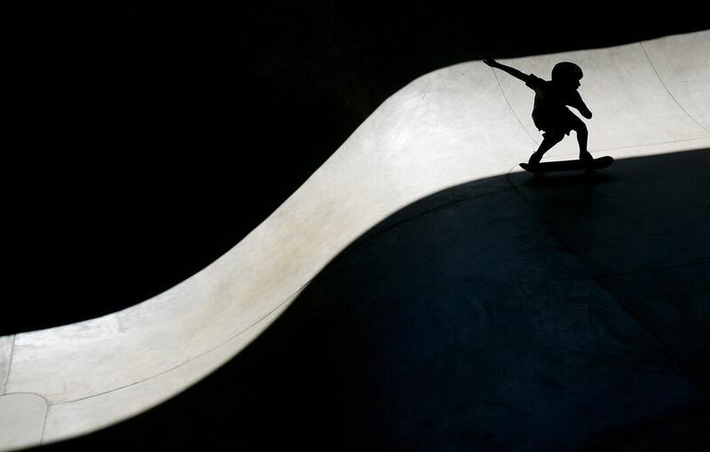 Ten-year-old Dylan Pacheco, from Jerome, Idaho, skates along a a ribbon of sunlight at the Rhodes Skate Park grand opening in Boise, Idaho. Kyel Green / Idaho Statesman via AP