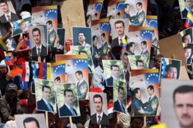 Syrians hold pictures of their president, Bashar Assad, and his Venezuelan counterpart, Hugo Chávez, during the latter's visit to Suweida on September 4.