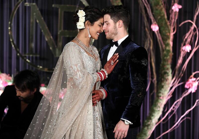 Newlyweds Priyanka Chopra, 36, and Nick Jonas, 26, pose for a photograph during a reception at a hotel in New Delhi on December 4, 2018. Photo: EPA