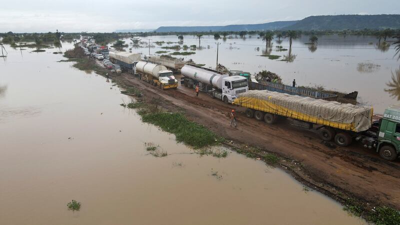 Flood waters surround a road at Lokoja. About 1.3 million people have been displaced nationwide. Reuters