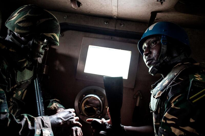 A picture taken on November 13, 2018, shows Tanzanian soldiers from the United Nations Organization Stabilization Mission in the Democratic Republic of the Congo (MONUSCO) sitting in a vehicle as they patrol against Ugandan Allied Democratic Force (ADF) rebels in Beni. The Beni area has for the last four years been under seige from the ADF, an Islamist armed group that has killed hundreds of people since 2014. / AFP / John WESSELS
