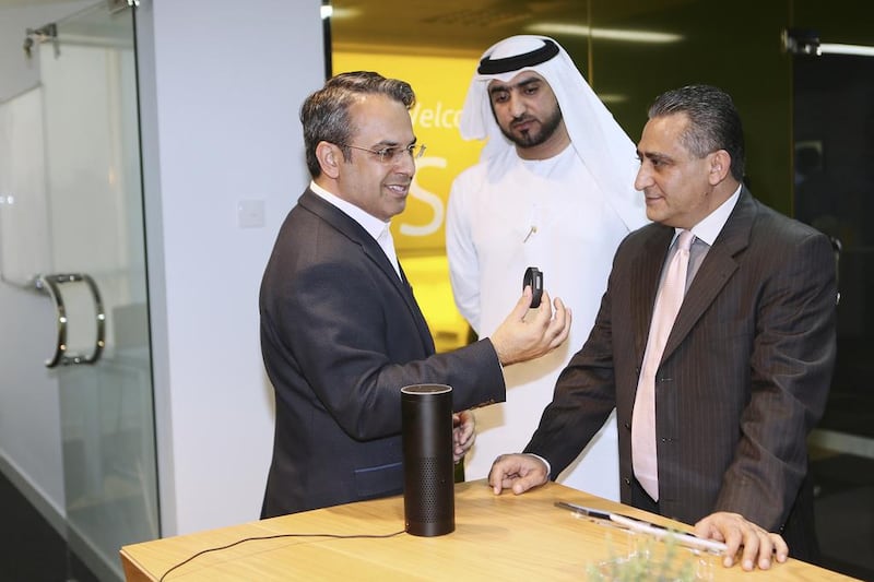 Vimal Sethi, left, managing director of Synechron Middle East, makes a demonstration at the Synechron launch in Dubai Media City. Sarah Dea / The National