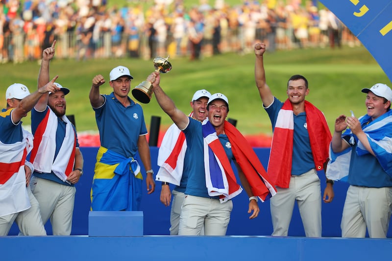 Viktor Hovland, holding the Ryder Cup trophy, came of age in Rome and proved why he is one of the best players in the world. Getty