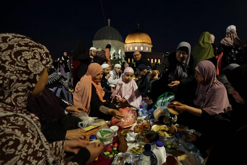 Palestinians break their fast during Ramadan. AFP