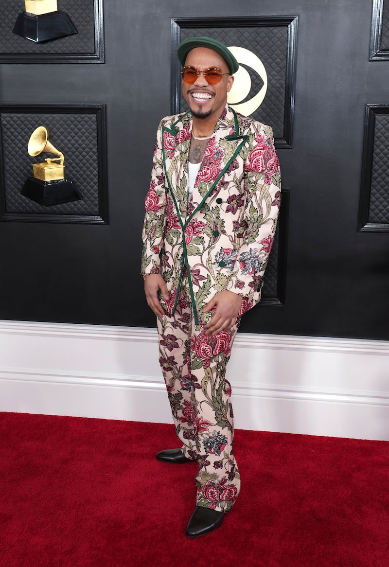 Anderson. Paak arrives in a floral suit and flat cap. AP