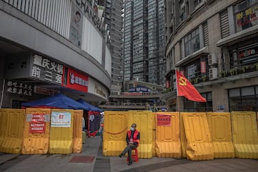 epa08334775 A public security volunteer sits at the entrance of a shopping and residential area in Wuhan, China, 31 March 2020. Wuhan, the epicenter of the coronavirus outbreak, partly lifted the lockdown allowing people to enter the city after more than two months. Chinese authorities eased the quarantine measures as cases of COVID-19 disease across China have plummeted, according to Chinese government figures. EPA/ROMAN PILIPEY