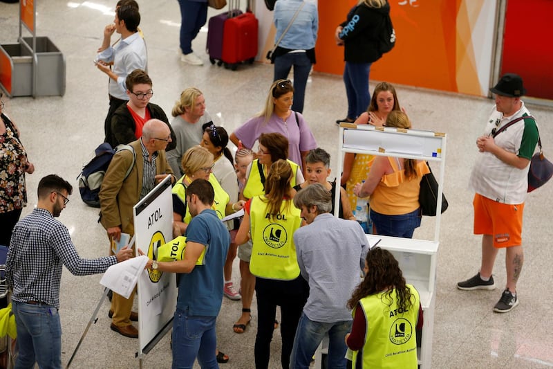 Passengers talk to the Civil Aviation Authority after the world's oldest travel firm collapsed stranding hundreds of thousands of holidaymakers around the globe and sparking the largest peacetime repatriation effort in British history, in Palma de Mallorca, Spain. Reuters