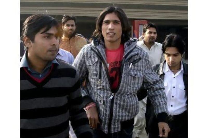 Mohammad Aamer, centre, is planning to appeal. KM Chaudary / AP Photo