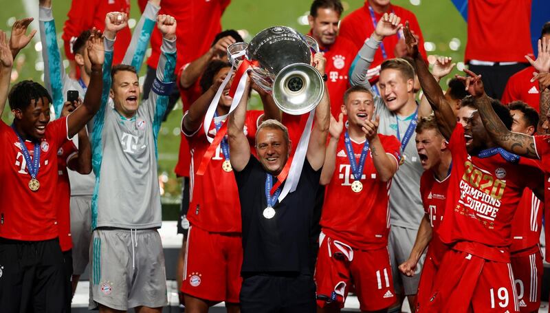 Bayern Munich's German coach Hans-Dieter Flick raises the European Champion Clubs' Cup during the trophy ceremony after winning at the end of the UEFA Champions League final football match between Paris Saint-Germain and Bayern Munich at the Luz stadium in Lisbon on August 23, 2020. (Photo by MATTHEW CHILDS / POOL / AFP)