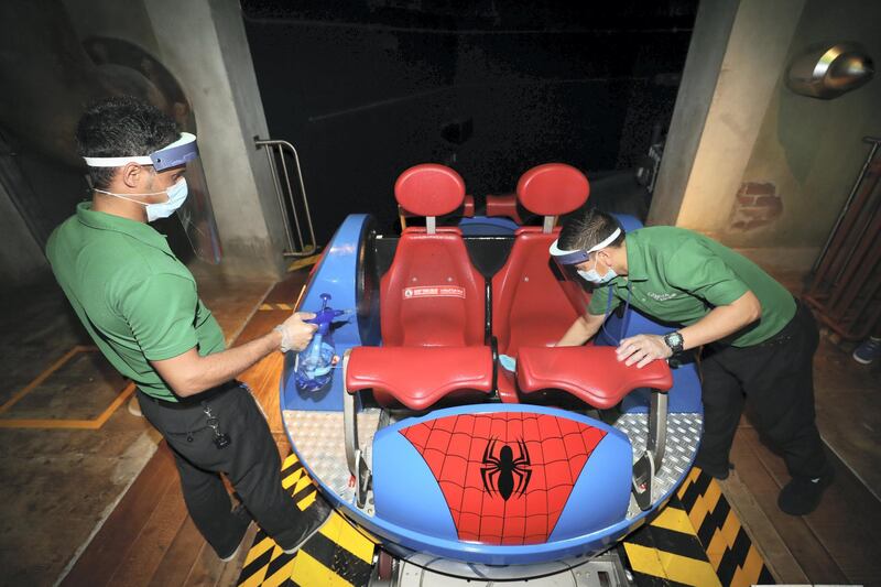 Dubai, United Arab Emirates - Reporter: N/A. Covid-19/Coronavirus. Sarfarag (L) and Surya clean the Spiderman ride. IMG World of Adventure opened on recently to the public with strict Covid-19/Coronavirus safety measures. Tuesday, July 21st, 2020. Dubai. Chris Whiteoak / The National