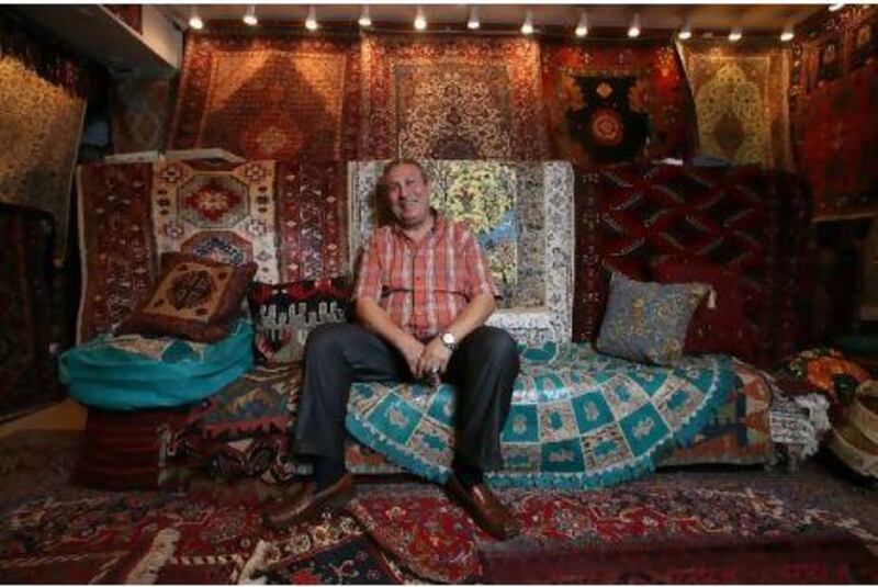 "When you buy something you like, you sell it also with love," says Attif Hellal, the owner of Tabriz Carpet and Novelty Exhibition, at his store in the Central Market in Sharjah.