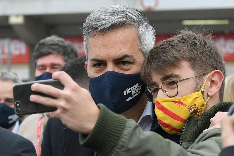 Candidate for Barcelona presidency Victor Font poses for a selfie with a supporter after voting for Barcelona presidential election on Sunday, March 7, outside Camp Nou in Barcelona. AFP
