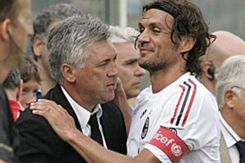 The departing AC Milan coach Carlo Ancelotti, left, is embraced by outgoing captain Paolo Maldini after their final match of the season against Fiorentina in Florence. It was the last game at the club for both of them.