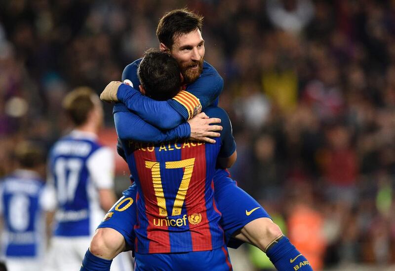 Barcelona forward Paco Alcacer celebrates a goal with Barcelona’s Argentine forward Lionel Messi. Lluis Gene/ AFP