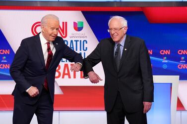 Democratic US presidential candidates Joe Biden and Senator Bernie Sanders greet each other with an elbow bump in place of a handshake before the start of the 11th Democratic candidates’ debate. Reuters