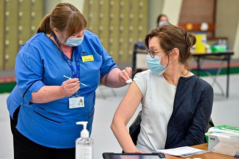 BEARSDEN, SCOTLAND - MAY 14: Natalyia Dasiukevich receives her Covid‚Äì19 vaccination from nurse Carol McGlion at Allander Sports Centre on May 14, 2021 in Glasgow, Scotland.  Scotland's Covid-19 vaccination programme has reached a major milestone as the number of jabs given passed the three million mark. (Photo by Jeff J Mitchell - Pool/Getty Images)