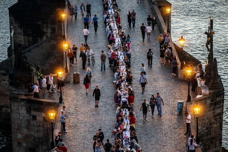Residents sit to dine on a 500-metre long table set on the Charles Bridge, after restrictions were eased following the coronavirus pandemic in Prague, Czech Republic. Getty Images