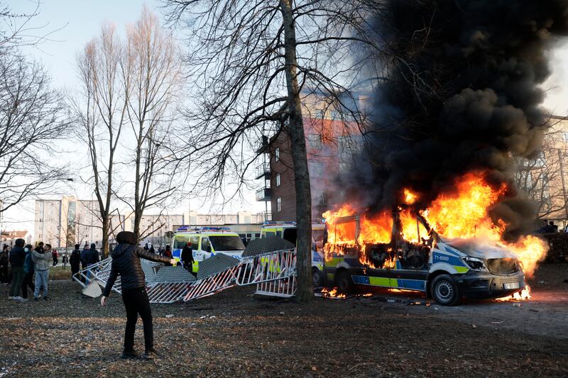 Protesters set fire to a police minibus at Sveaparken, Orebro, south-central Sweden. Rasmus Paludan has been touring the country and at each gathering has attempted to burn a Quran. AP