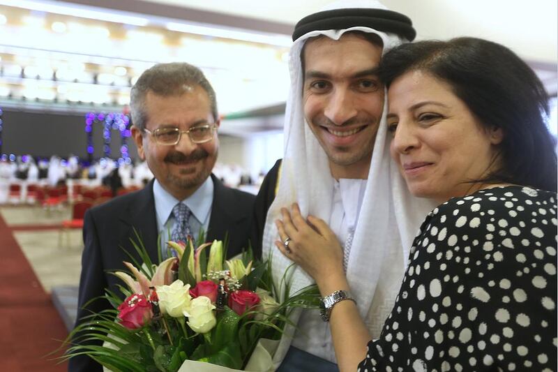 Wael Salha, 23, is congratulated by his father, Sami and his mother, Bassima,4. Delores Johnson / The National