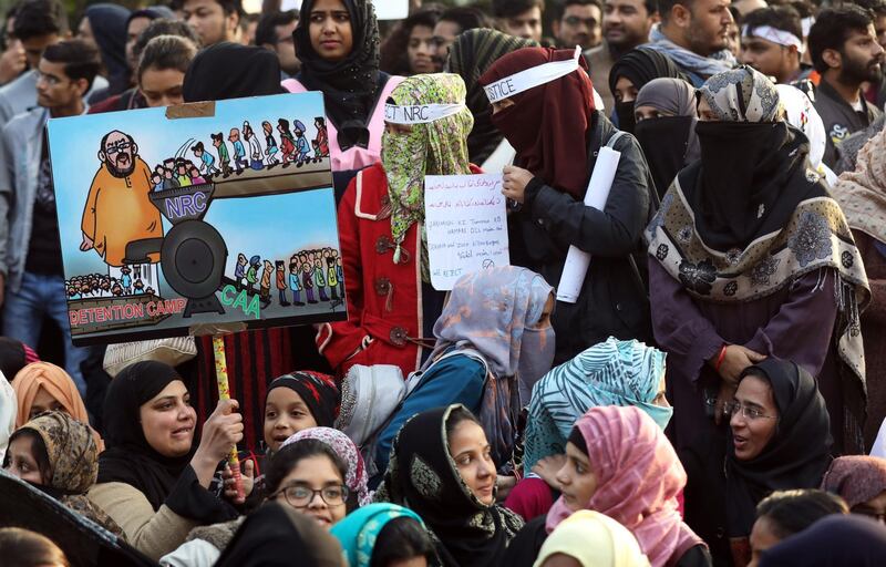 Indian activists hold placards and shout slogans as they protest against Citizen Amendment Act(CAA) outside Jamia Millia Islamia University, in New Delhi.  EPA