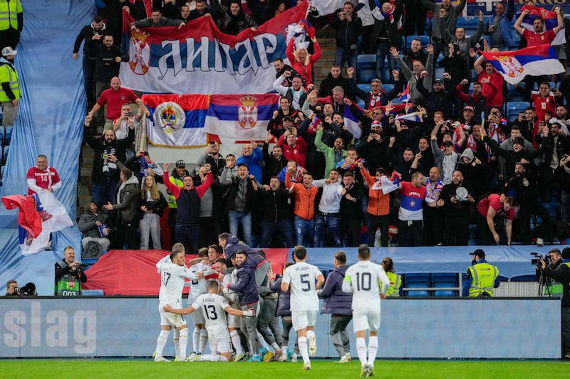 Serbia's players celebrate in front of their supporters after Aleksandar Mitrovic scores against Norway. AFP