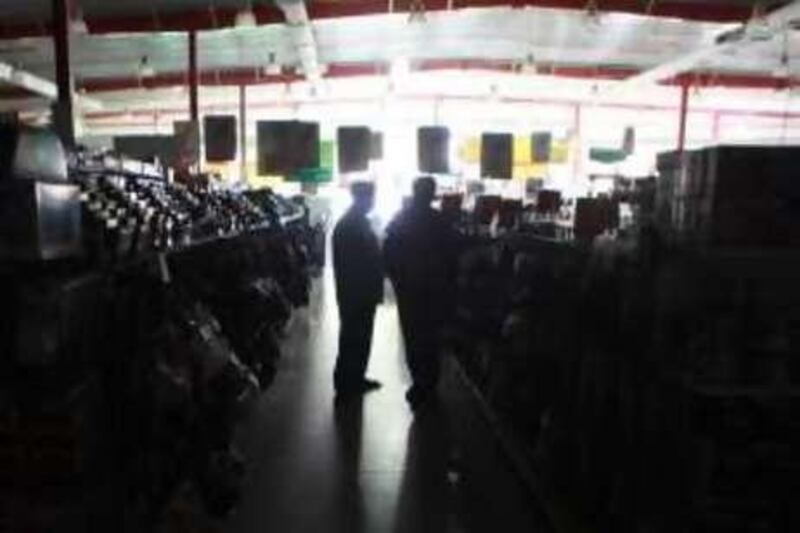 United Arab Emirates - Sharjah - May 30th, 2010:  Costumers in Macro supermarket shop in the dark during a blackout.  (Galen Clarke/The National)