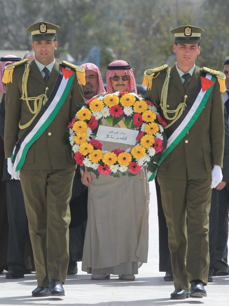 Saudi Prince Al Waleed Bin Talal visits the grave of former Palestinian leader Yasser Arafat at his mausoleum in the Muqataa Compound on March 4, 2014, during an official visit to the West Bank city of Ramallah. The billionaire is in the Israeli-occupied West Bank for a meeting with Palestinian president Mahmud Abbas. Abbas Momani / AFP photo