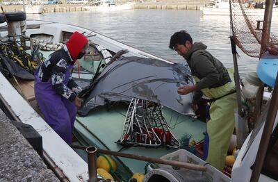 Recovered debris, believed to be part of wreckage from a crashed US Air Force Osprey, being brought ashore in Japan. AFP