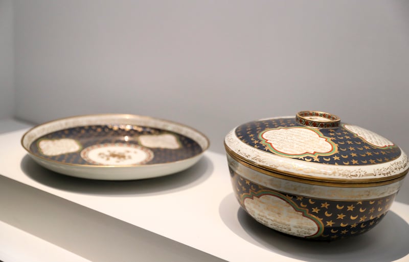 Bowl with lid and platter with Arabic inscriptions from China's Jiangxi Province dating back to the 18th century. Khushnum Bhandari / The National