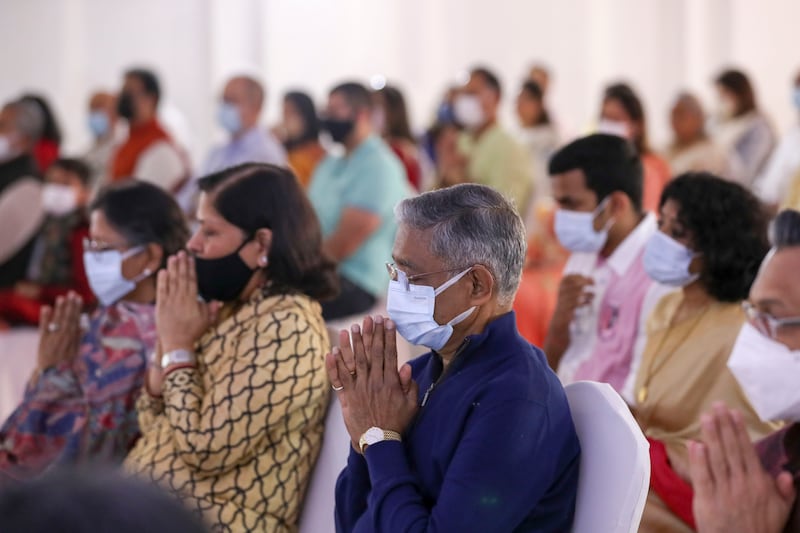 Guests attend a prayer ceremony as construction work gets under way at the temple. Khushnum Bhandari / The National