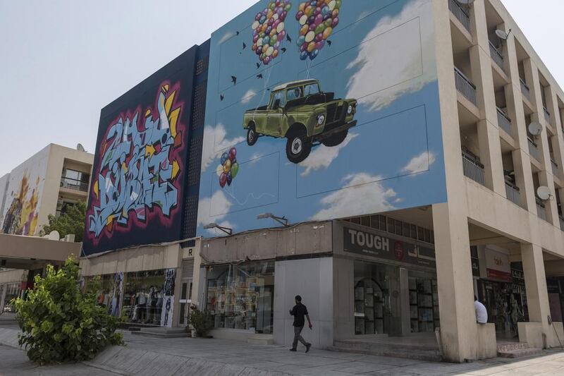 Eight street artists have helped give the area a facelift by painting 24 huge murals on the side of 12 apartment buildings and shops around the Karama shopping complex. Antonie Robertson / The National