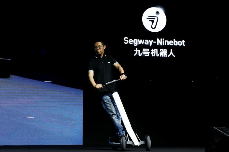 Ninebot President Wang Ye unveils semi-autonomous scooter KickScooter T60 that can return itself to charging stations without a driver, at a Segway-Ninebot product launch event in Beijing, China August 16, 2019.  REUTERS/Florence Lo