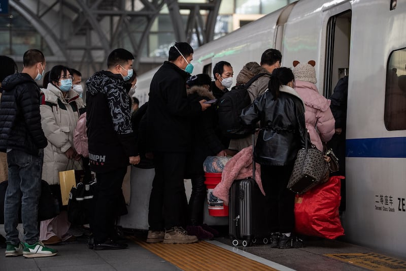 Passengers board their train at Hankou railway station in Wuhan. AFP