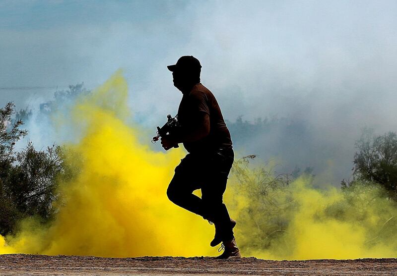 An Iraqi soldier runs while Australian and New Zealand coalition forces participate in a training mission with Iraqi army soldiers at Taji Base, north of Baghdad. AP Photo