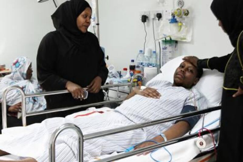 


DUBAI, UNITED ARAB EMIRATES Ð Sept 15: Ahmed Fayrous getting treatment at Rashid Hospital in Dubai. His mother sitting on the left side. The two women beside the bed are other family members. Please note none of the women in the photograph wanted to be named 
 (Pawan Singh / The National) For News. Story by Manal
