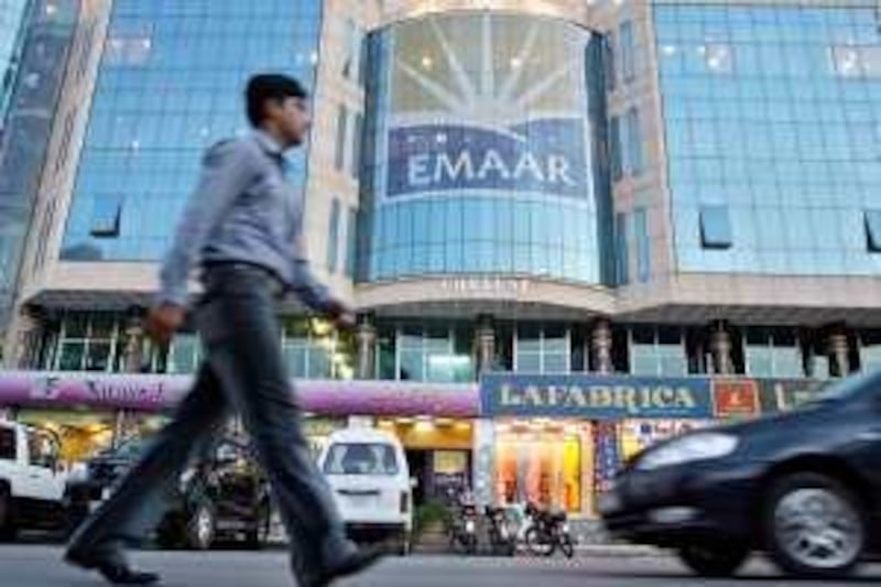 A Pakistani man walks past a building showing the advertisement of construction group, Emaar in Islamabad, 29 September 2006.  Pakistan has allotted 12,000 acres of land to Gulf construction group Emaar to develop two islands off the Karachi coastline at a cost of 43 billion USD, officials said. AFP PHOTO/Farooq NAEEM