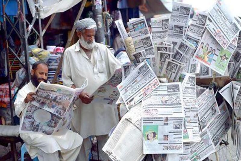 Pakistani men in Rawalpindi read the newspapers a day after the country’s landmark general elections.