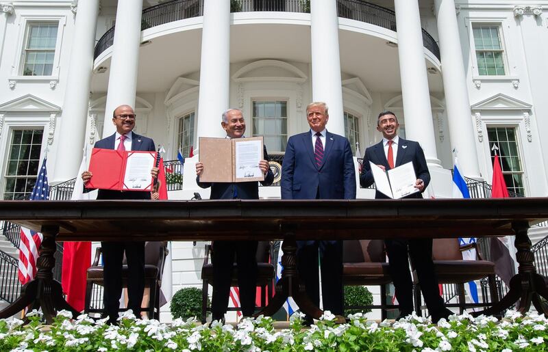 (L-R)Bahrain Foreign Minister Abdullatif al-Zayani, Israeli Prime Minister Benjamin Netanyahu, US President Donald Trump, and UAE Foreign Minister Abdullah bin Zayed Al-Nahyan hold up documents after participating in the signing of the Abraham Accords where the countries of Bahrain and the United Arab Emirates recognize Israel, at the White House in Washington, DC, September 15, 2020. - Israeli Prime Minister Benjamin Netanyahu and the foreign ministers of Bahrain and the United Arab Emirates arrived September 15, 2020 at the White House to sign historic accords normalizing ties between the Jewish and Arab states. (Photo by SAUL LOEB / AFP)