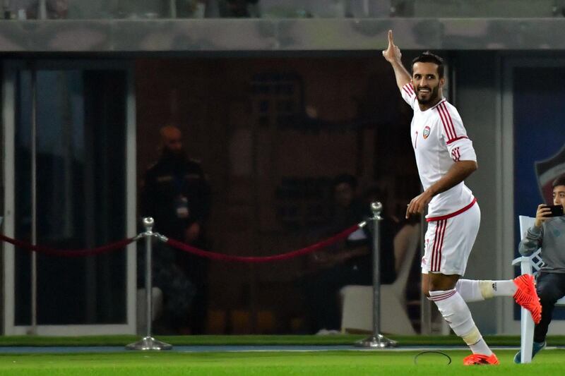 Emirates' Ali Mabkhout (R) celebrates after scoring during their 2017 Gulf Cup of Nations football match between UAE and Oman at the Sheikh Jaber al-Ahmad Stadium in Kuwait City on December 22, 2017. / AFP PHOTO / GIUSEPPE CACACE