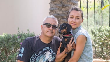 Adrienn Remenyi and David Connell with their surviving miniature dachshund Frankie at their home in Ras Al Khaimah. Leslie Pableo for The National