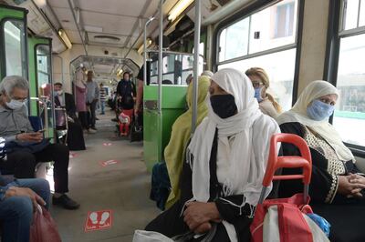 Women wearing face masks due to the COVID-19 coronavirus pandemic sit in a carriage of the Tunis metro in the centre of the capital Tunis on May 4, 2020, as Tunisian authorities begin a gradual sector and region-based deconfinement process. To find a balance between socio-economic needs and the preservation of health, the Tunisian government established a system in three stages, hoping to fully restart the country by June 14. / AFP / FETHI BELAID
