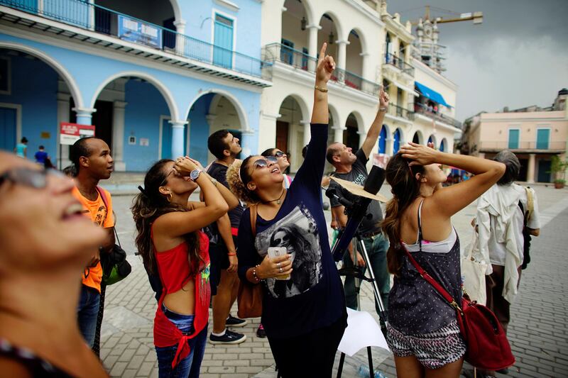 People look towards the sky as enthusiasts gather in Old Havana for the partial solar eclipse in Cuba. Alexandre Meneghini / Reuters