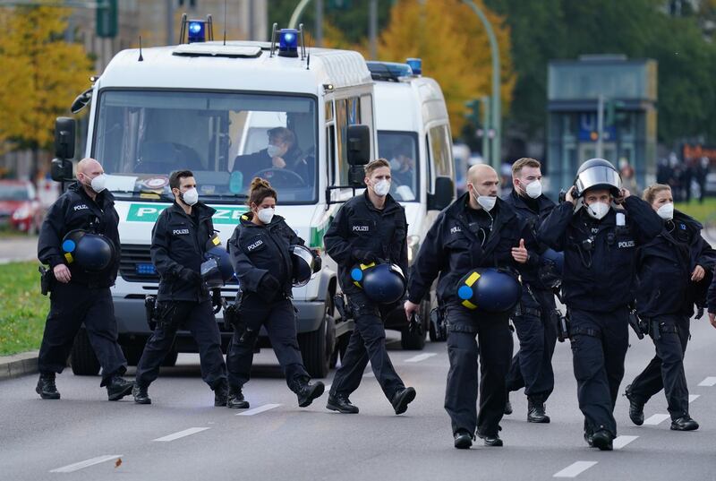 Police officers follow protesters in Berlin. Getty Images
