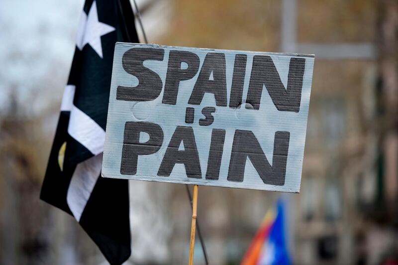 A protester holds a sign reading "Spain is pain" during a demonstration in Barcelona, Spain, on March 25, 2018. Josep Lago / AFP Photo